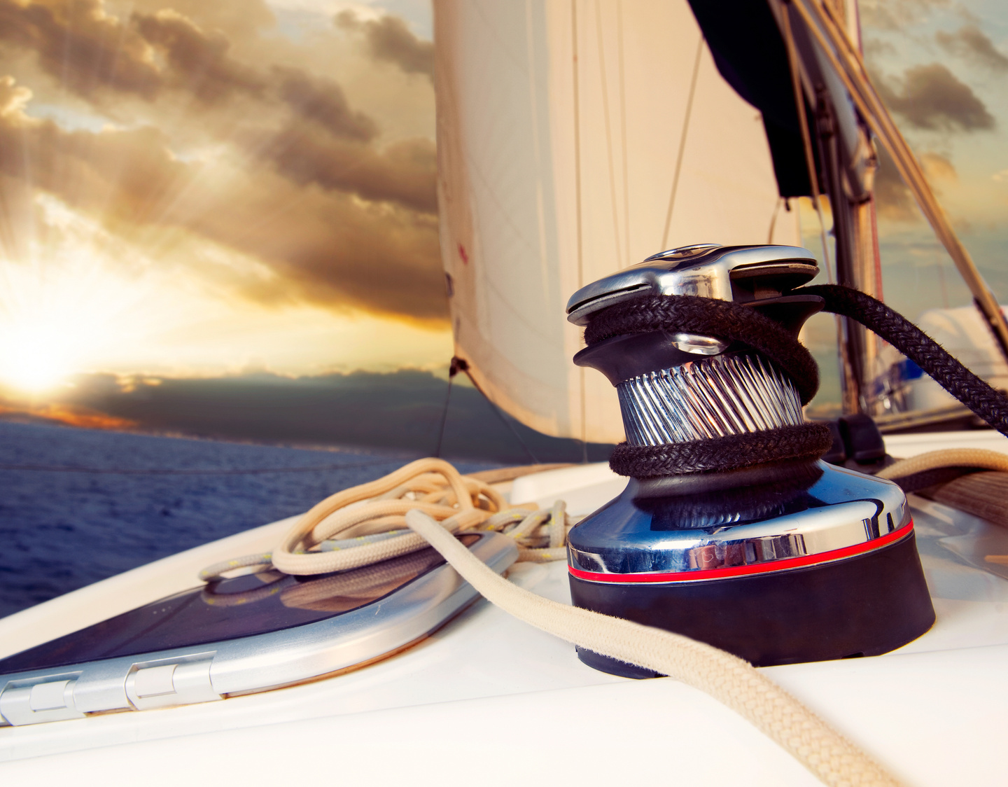 Yacht Sailing against Sunset 